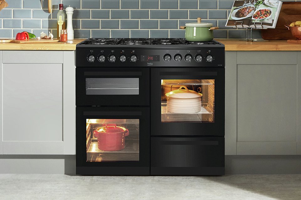 Pots and casseroles in a Beko KDVF100K 100cm Dual Fuel Range Cooker in a kitchen.