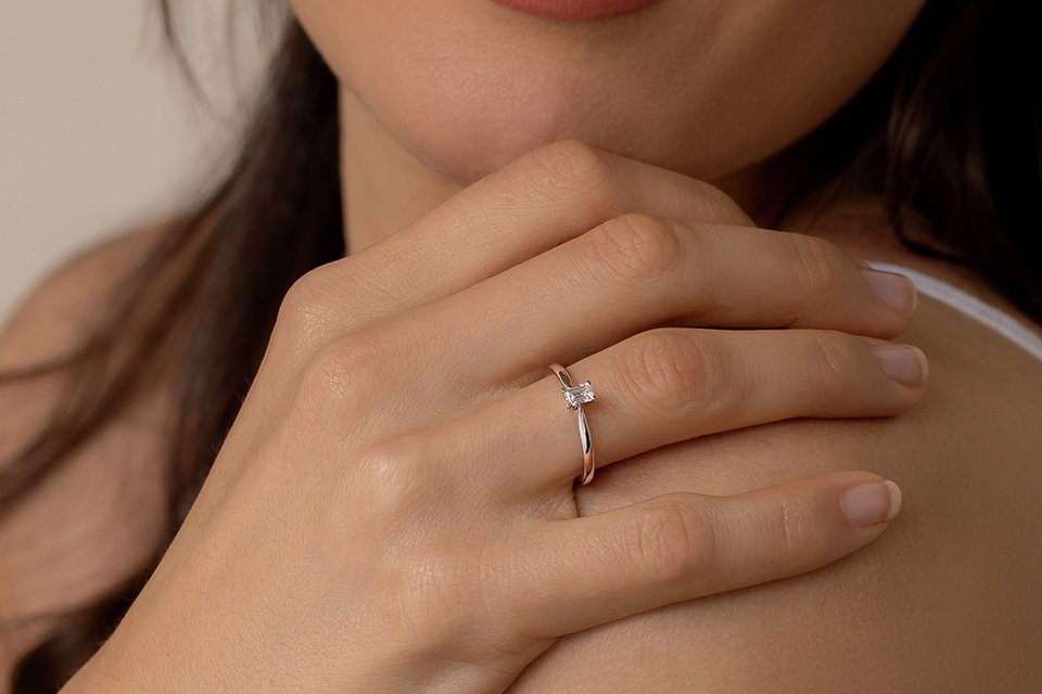 A woman wearing a princess cut ring.