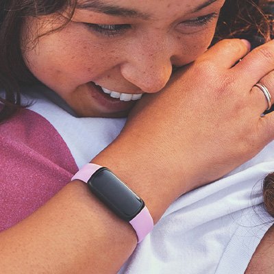 A girl wearing a yellow Fitbit Inspire 3 Fitness Tracker.