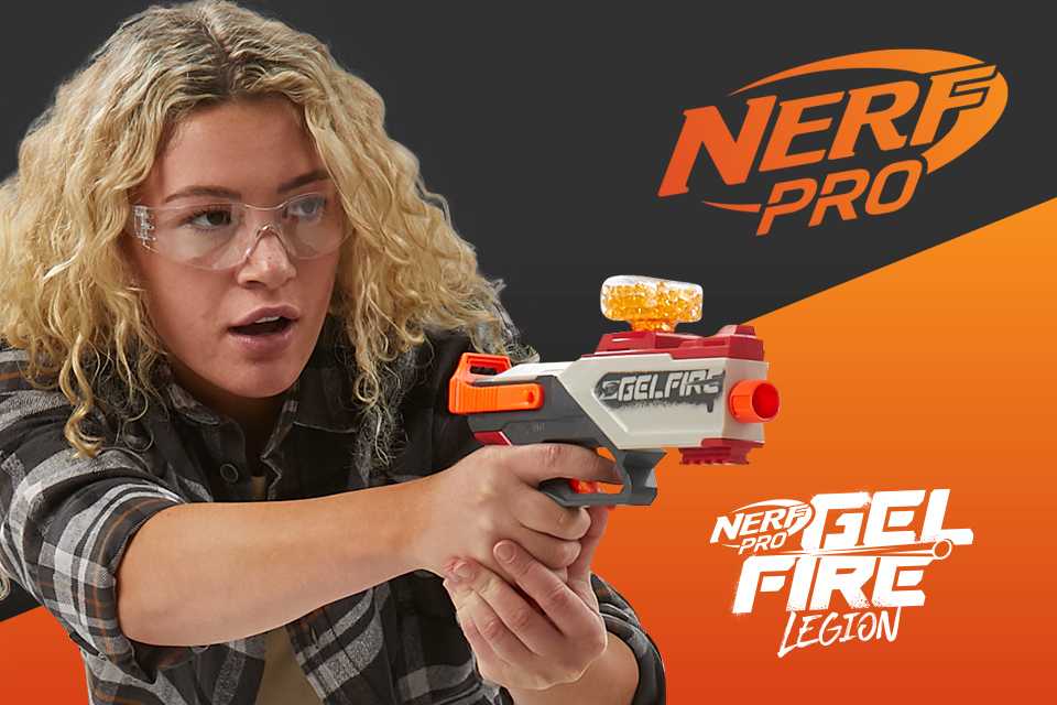 A young blonde girl posing with a Nerf Gelfire blaster.