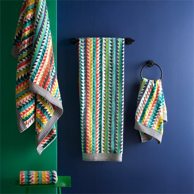 Colourful printed towels in bathroom.