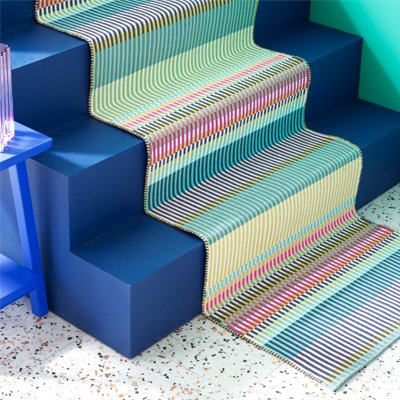 Colourful striped pattered runner down stairs.