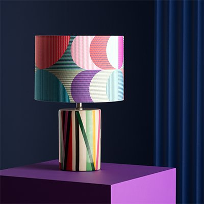 Colourful table lmap with colour circle print shade.