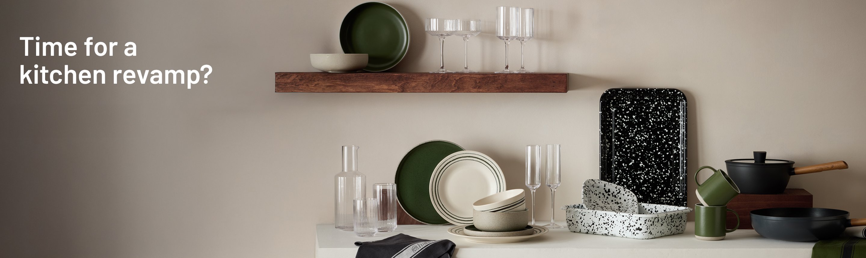 Habitat Splatter Enamel pie dish, baking tray and other dinnerware and glassware sets displayed on a white kitchen counter. 