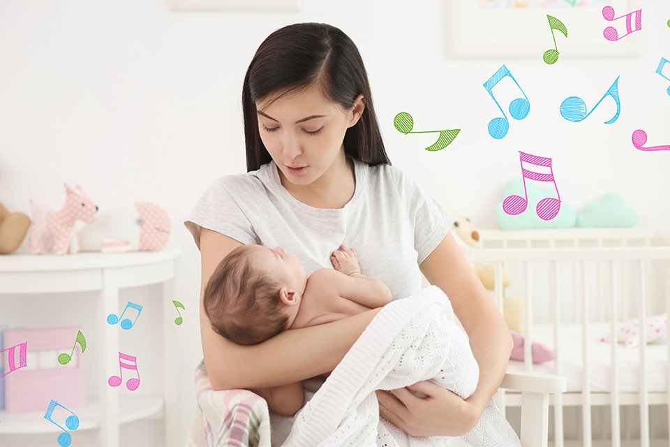 A baby monitor playing lullabies while a mother putting her baby to sleep.