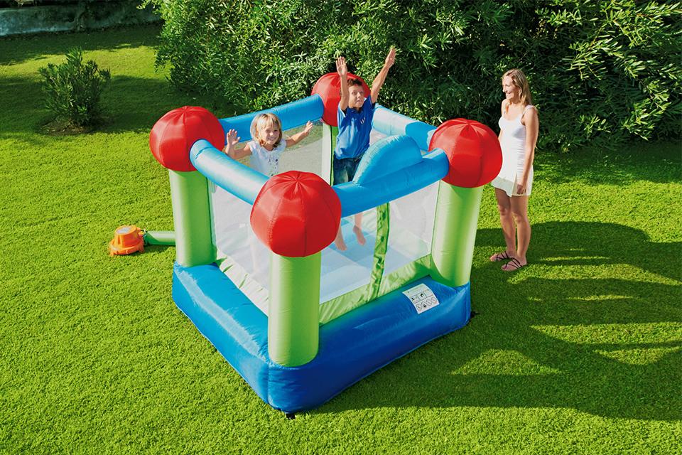 Two kids playing on the Chad Valley six foot bouncy castle in blue, green and red.