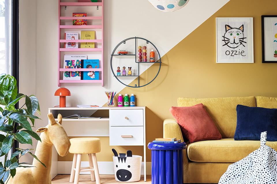 Yellow living room with kids play and study area.