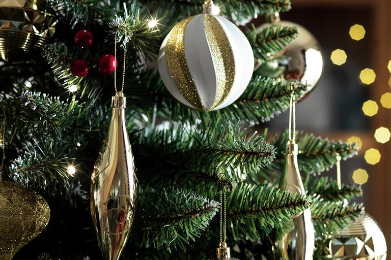 Gold and white baubles on a Christmas tree.