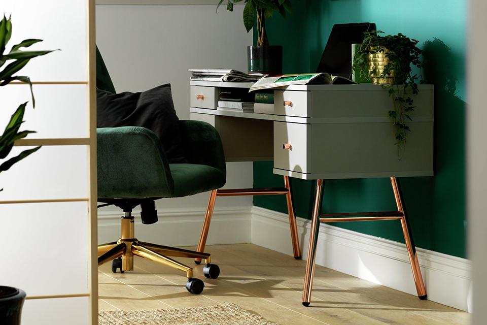 A home office with a filing cabinet, desk and ladder shelves.