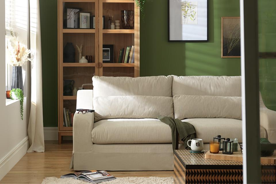 Cream sofa in a green living room.