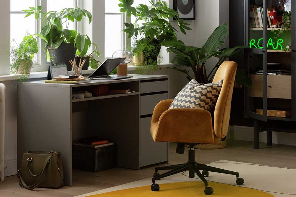 A home office set up with a Habitat 2 drawer desk and a mustard chair.