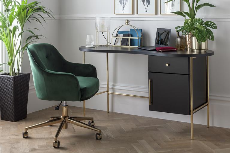 Stylish office desk and green velvet office chair.