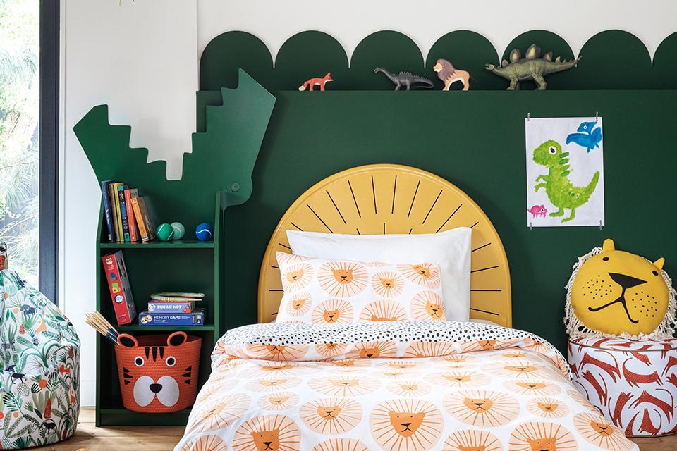 Jungle themed bedroom with printed duvet set and crocodile shaped bookcase.