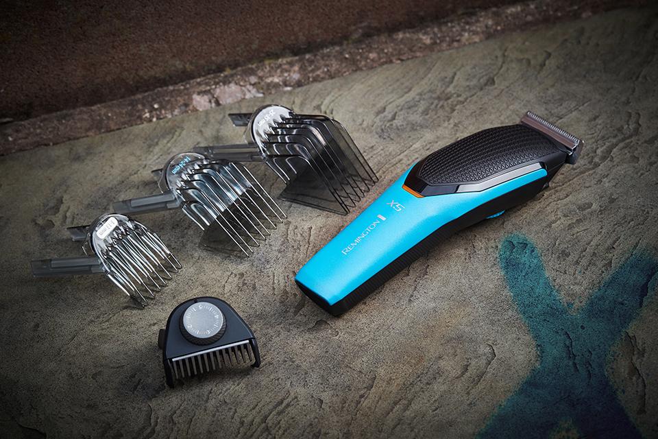 A blue Remington hair clipper is displayed to show the various attachments for different hair lengths.