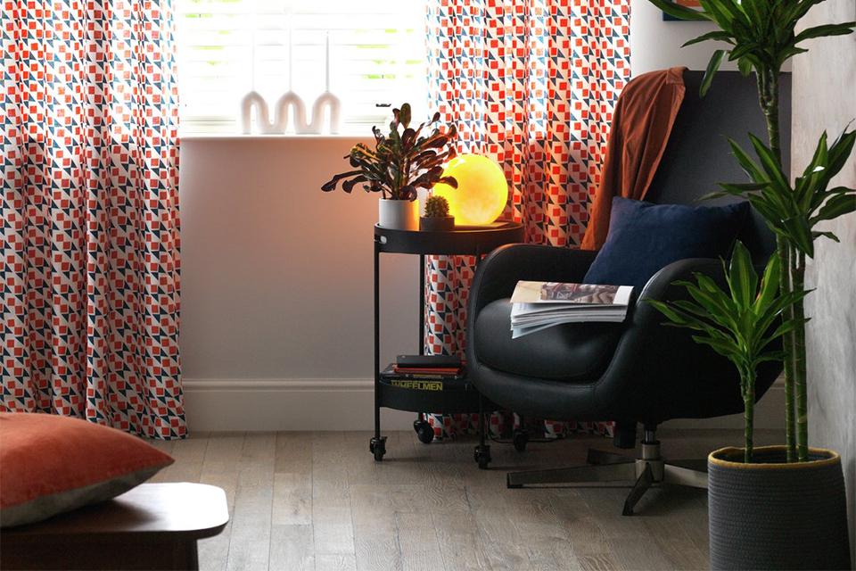 Habitat Geo navy & terracotta lined curtain in a living room.