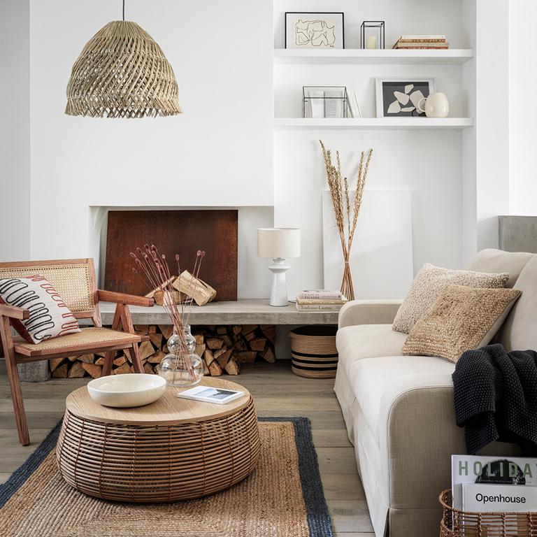 Image of white living room with natural and bohemian furniture and accessories.