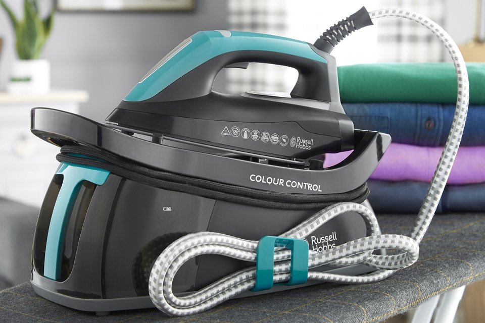 A Russell Hobbs Colour Control SteamPower steam generator iron sitting on an ironing board.