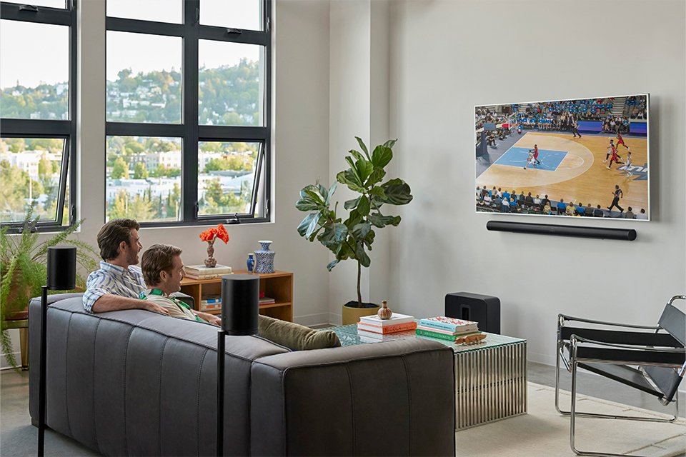 A family watching television in a modern living room.