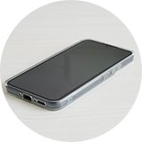 A phone with a clear phone case on a table.