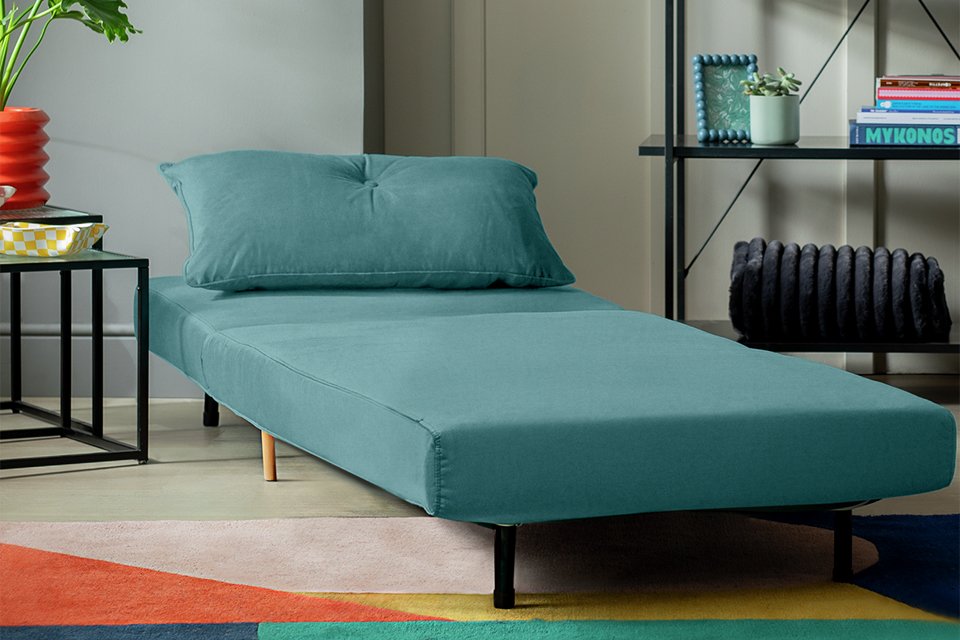 A Habitat velvet single chair bed in a living room.