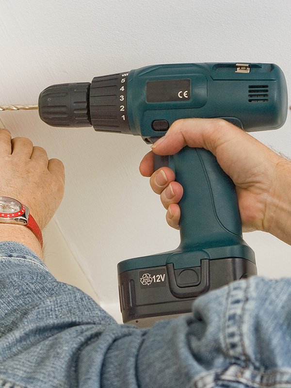 Drilling into a wall.