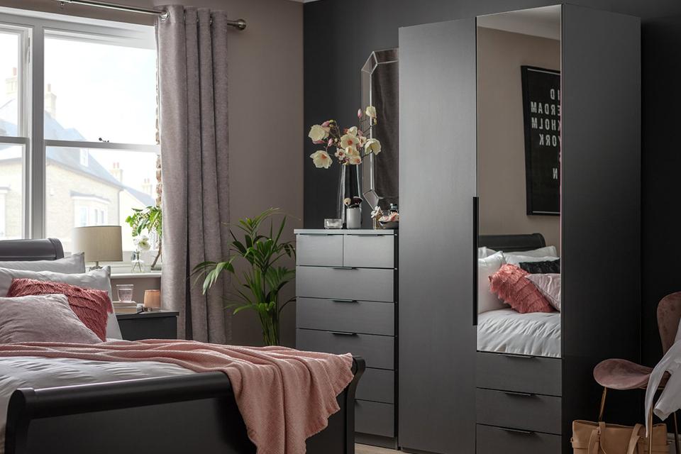 Grey toned bedroom with pink bedding.