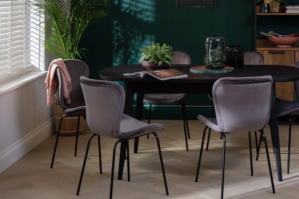 Black dining set with four velvet backed chairs.