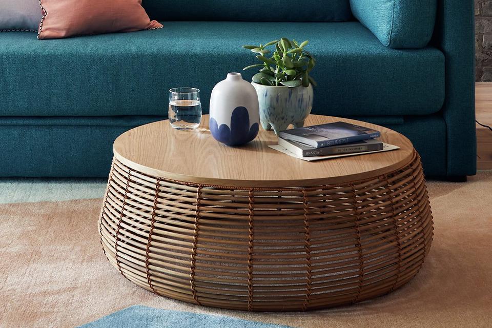 Image of a round, rattan coffee table.