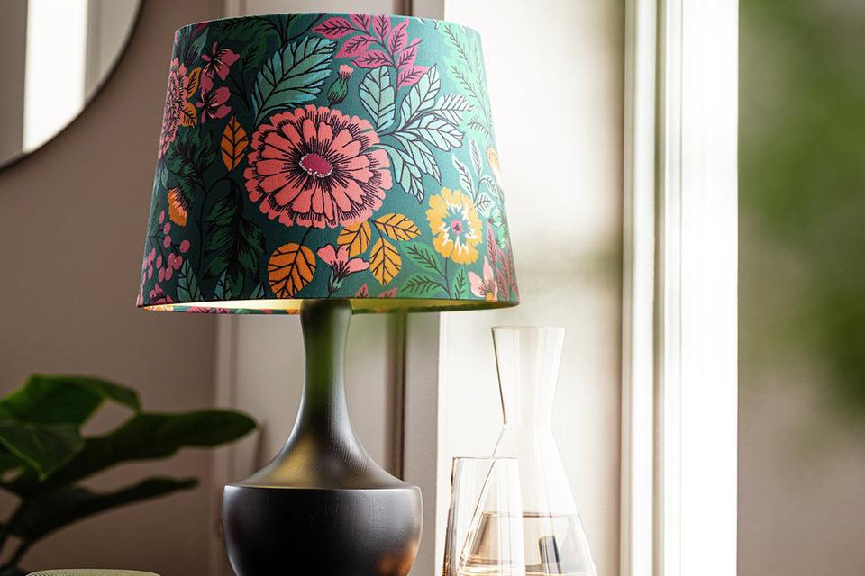 Image of a table lamp with a green and pink floral shade.