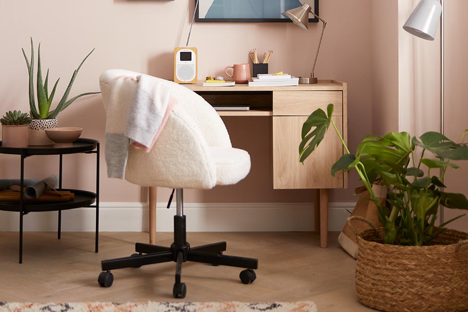 Image of a wooden desk and upholstered chair.
