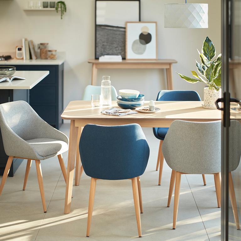 Image of a scandi style dining set with blue and grey chairs.