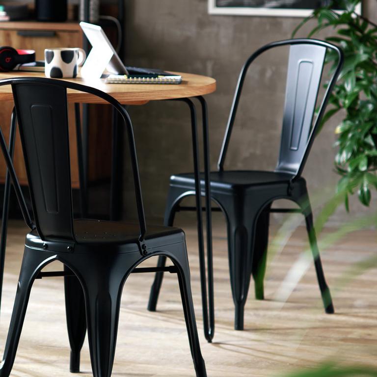 Image of an industrial style dining set with black chairs.