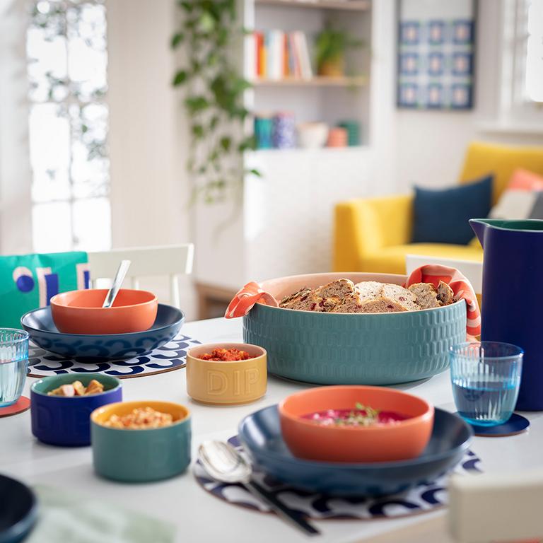 Image of dining table filled with colourful crockery.