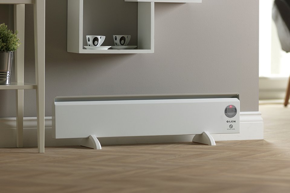 A Glen 500W Wall Mounted or freestanding skirt heater in a room near a table.