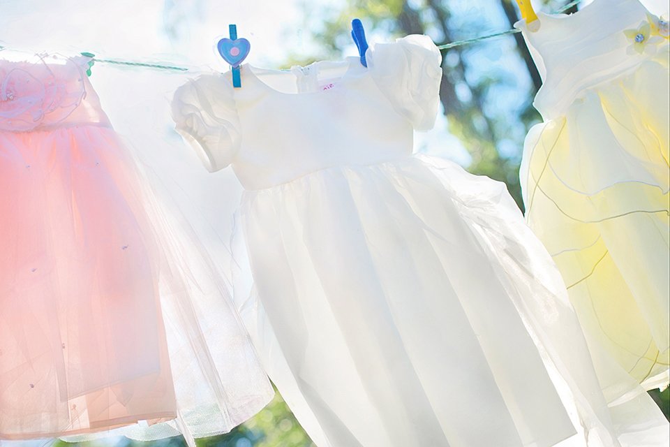 Some kids' clothes drying in the sun.