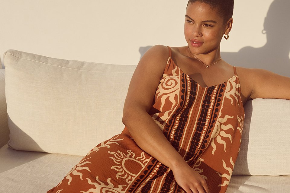 A lady in a sun printed strappy midaxi dress.