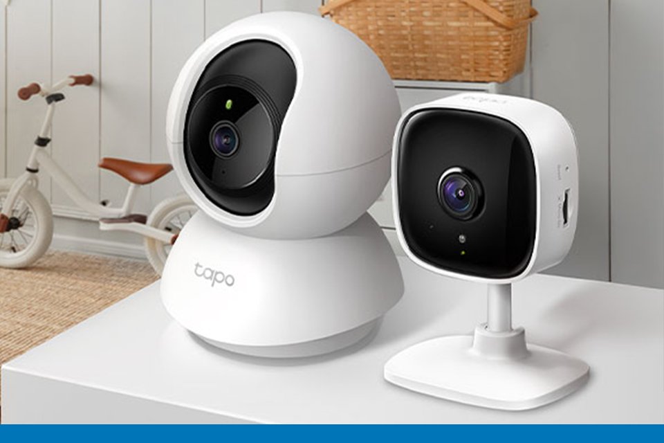 Two Tapo smart indoor Wi-Fi security cameras displayed on a white table top.