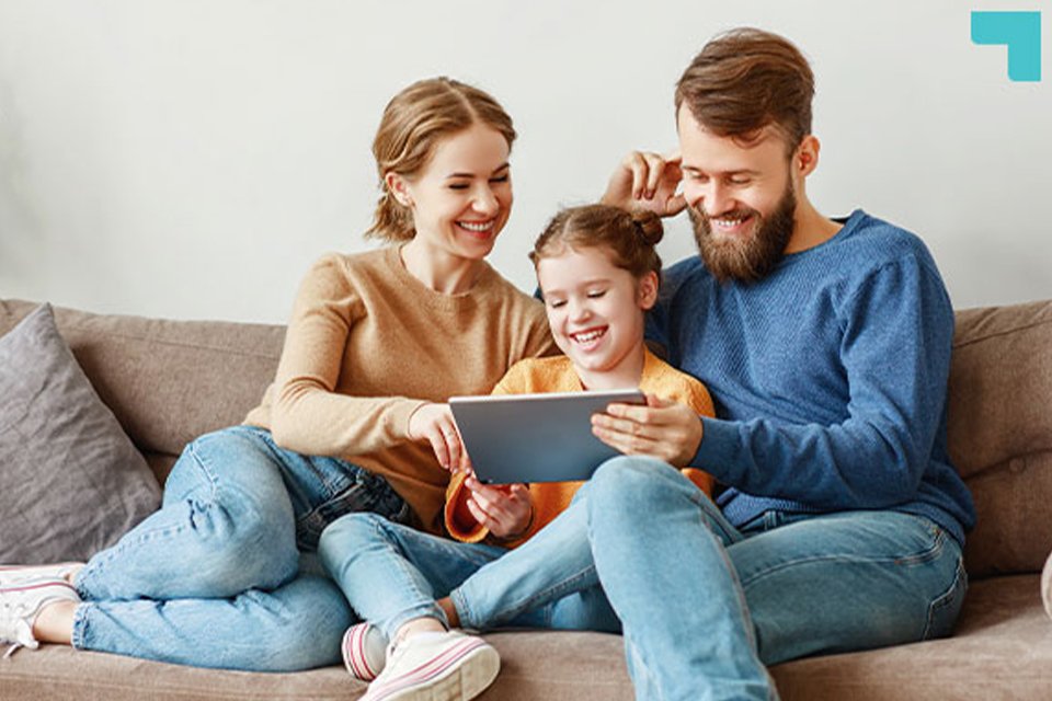 A family watching something on a tab and spending quality time together.