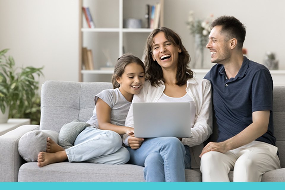A family spending time together while watching something on laptop connected via TP-Link Wi-Fi.