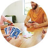 A family playing UNO card game.