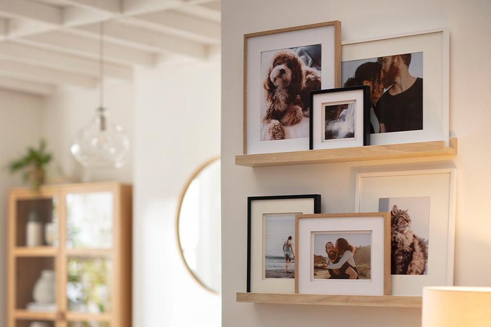 Image of wall shelves with selection of picture frames.