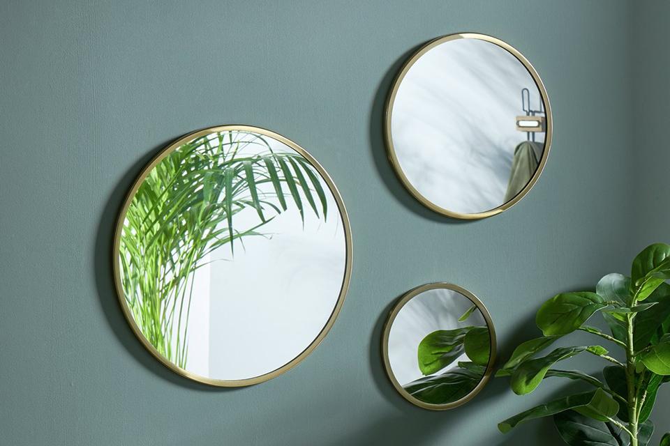 Small, medium and large mirrors with brass frames.