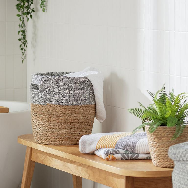 Neutral laundry basket in a white bathroom.