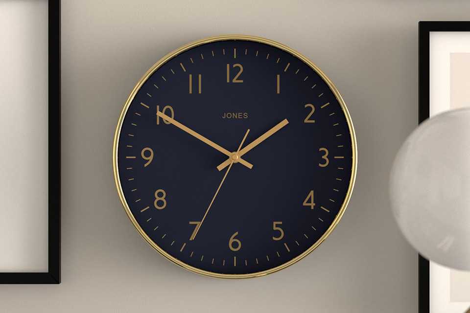 Navy and gold wall clock on wall.
