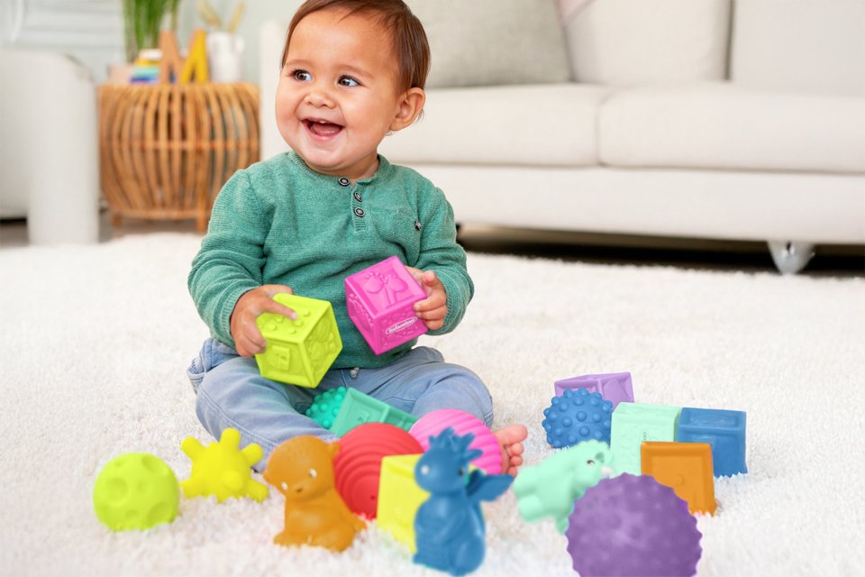 A toddler playing with colourful blocks.