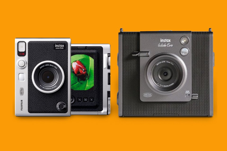 Two black instax™ hybrid instant cameras whereone is printing out a picture of flower.