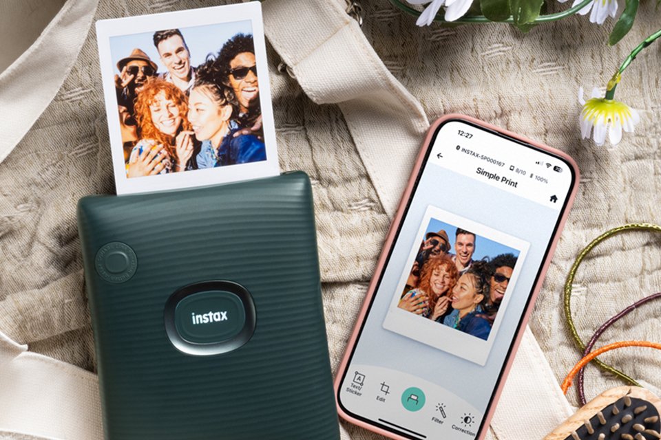 Someone printing a photo from a black instax SQUARE Link™ photo printer.