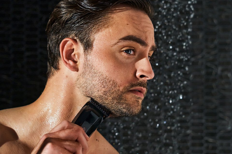 Shot of a man using a Manscaped product to shave his beard.