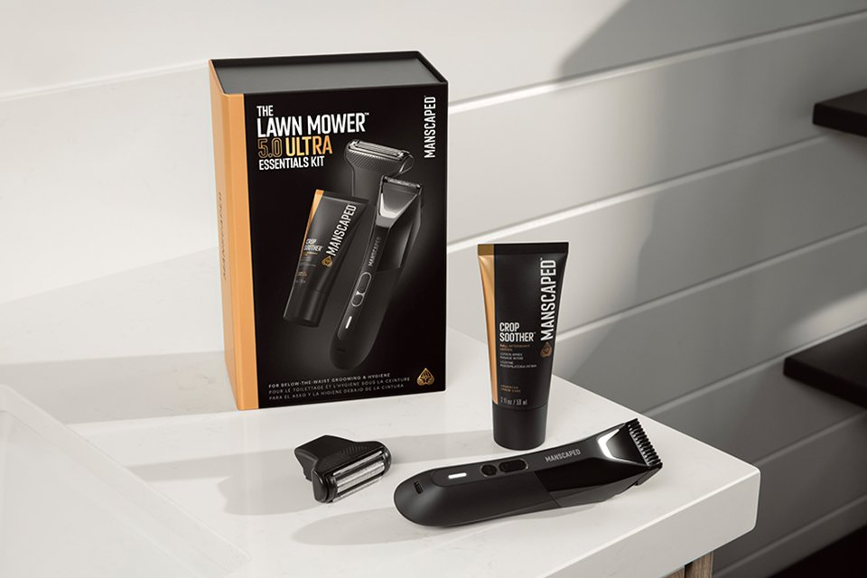 Shot of the Manscaped Lawn Mower 5.0 Ultra packaging, shaver, head and cream on a bathroom table.