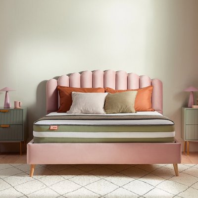 Pink headboard with mattress.